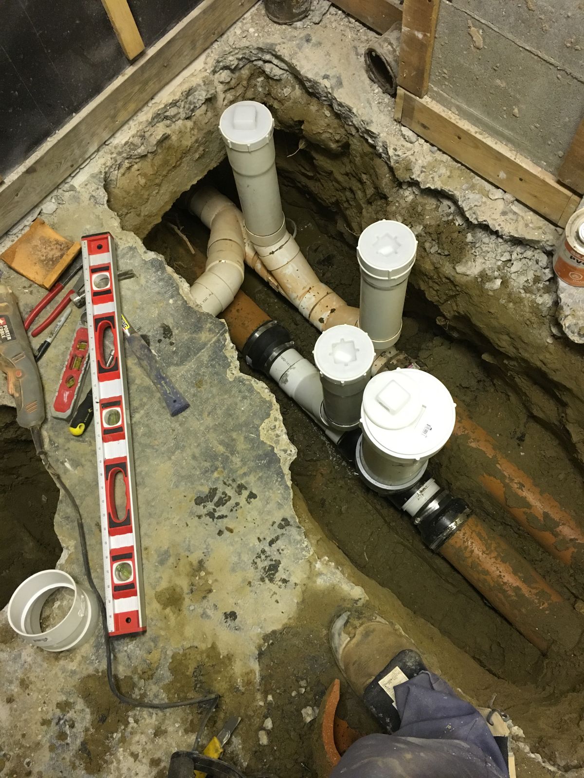 Mainline backwater valve and cleanouts installed under a basement floor